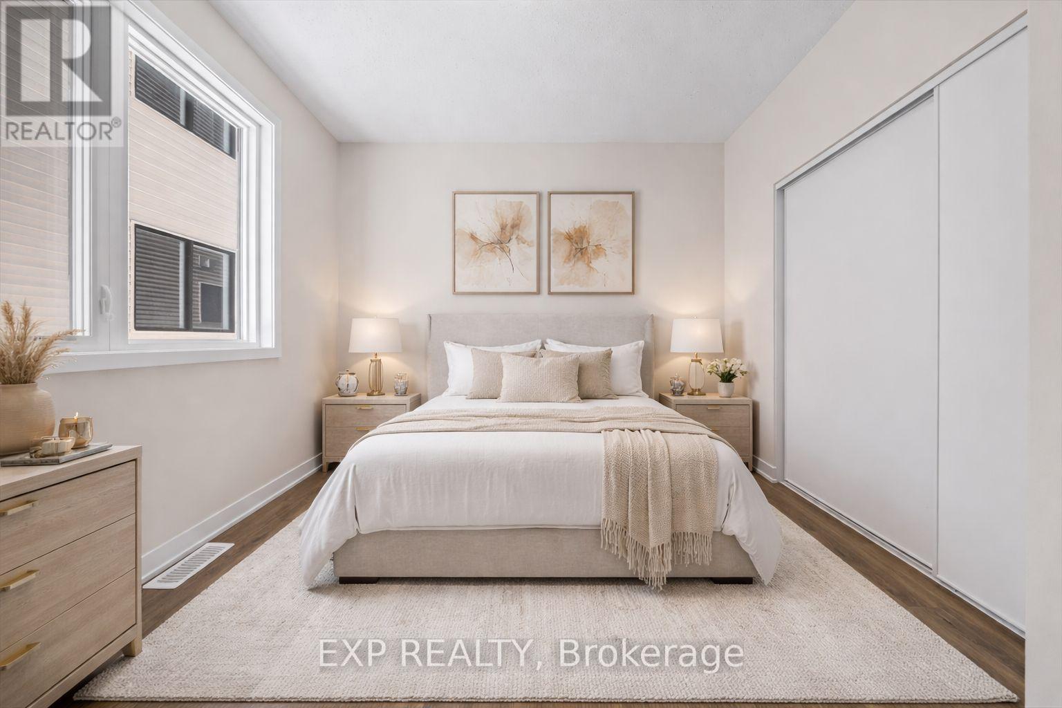 A bedroom with a large bed, two nightstands, and a dresser.