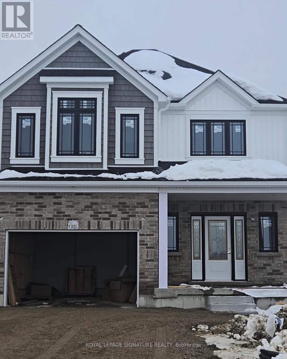 A house under construction with a garage door open.