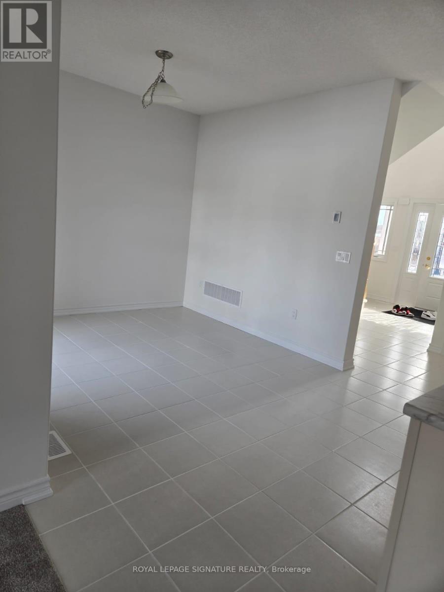 A room with white walls and a grey floor.