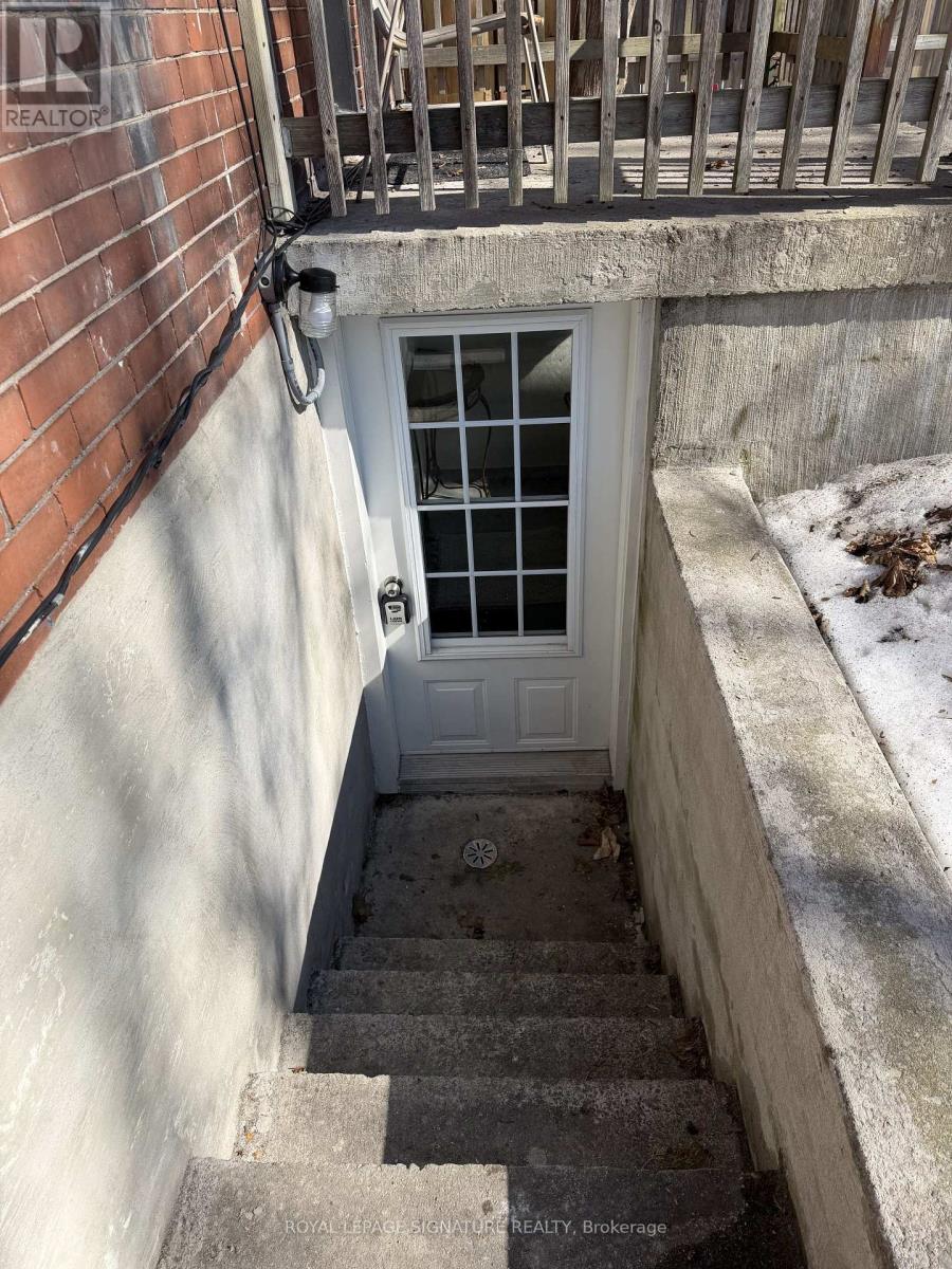 A set of stairs leading to a door with a window above it.