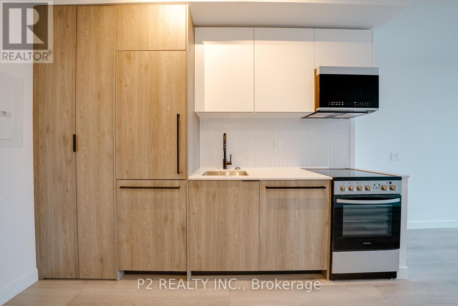 A modern kitchen with wooden cabinets and a stainless steel oven.