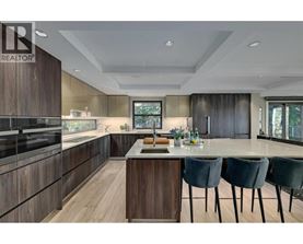 A modern kitchen with dark wood cabinets and a central island.