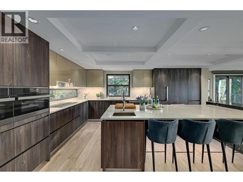 A modern kitchen with dark wood cabinets and a central island.
