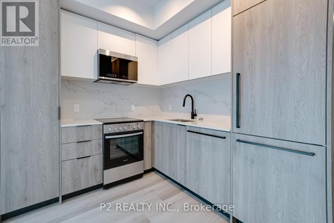 A modern kitchen with a stainless steel oven and a microwave above it.