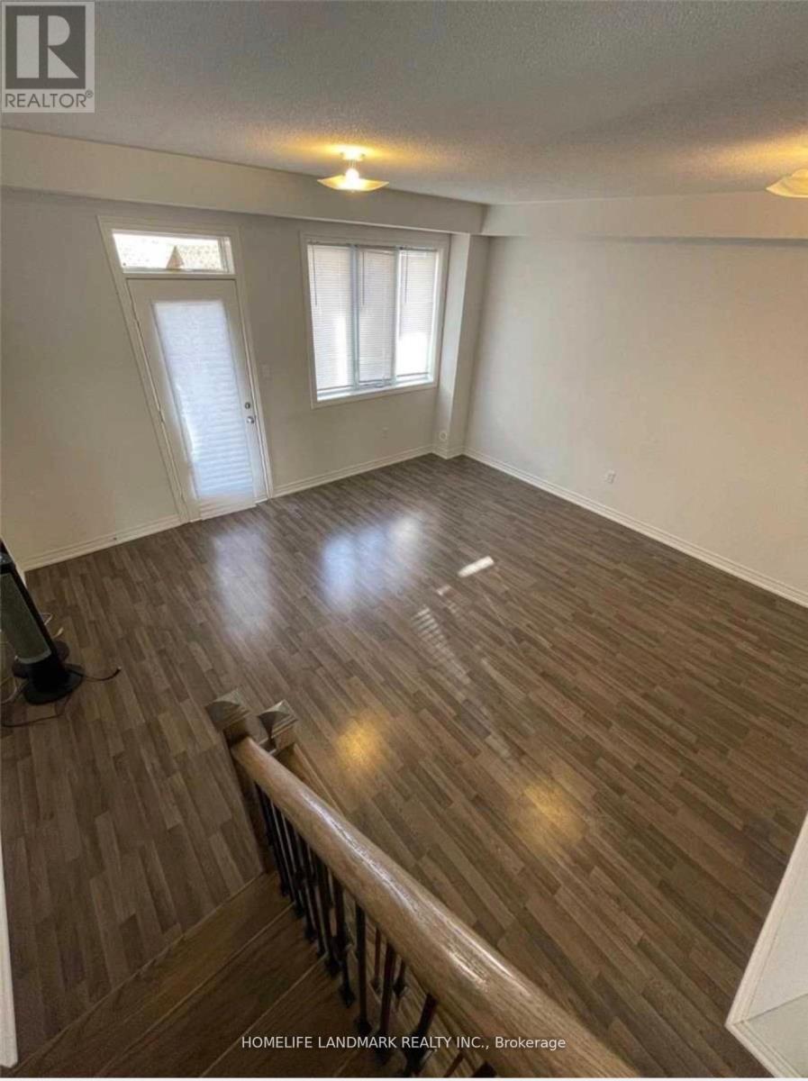 A room with wooden flooring and white walls.