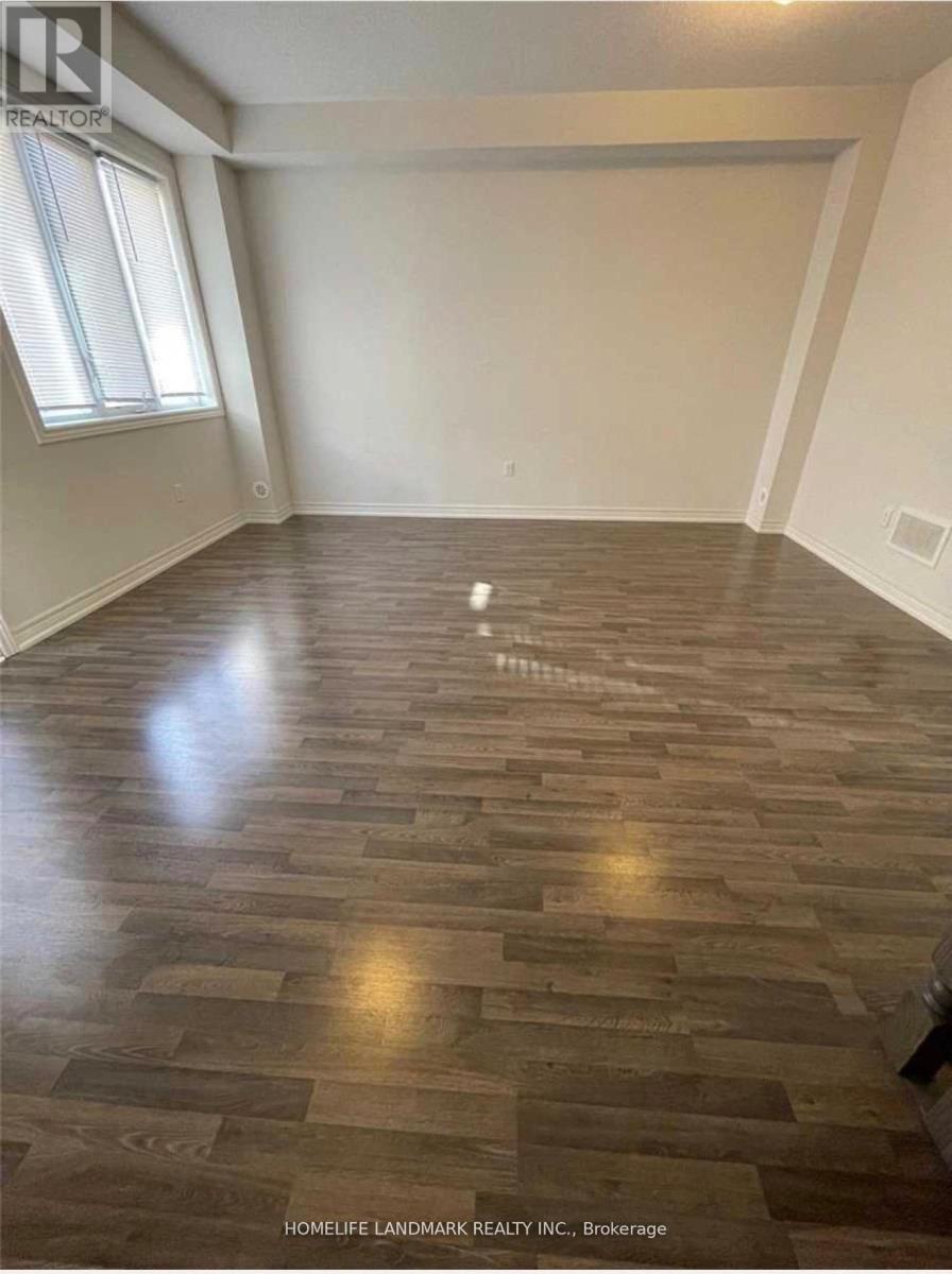 A room with wooden flooring and a window.