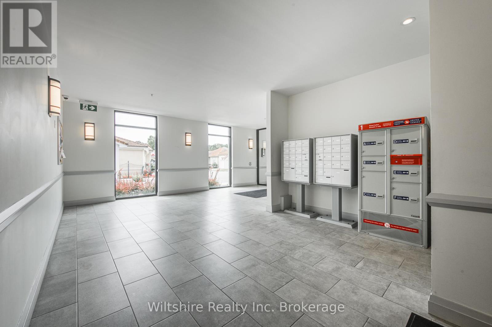 A brokerage office with a white wall and a calendar on the wall.