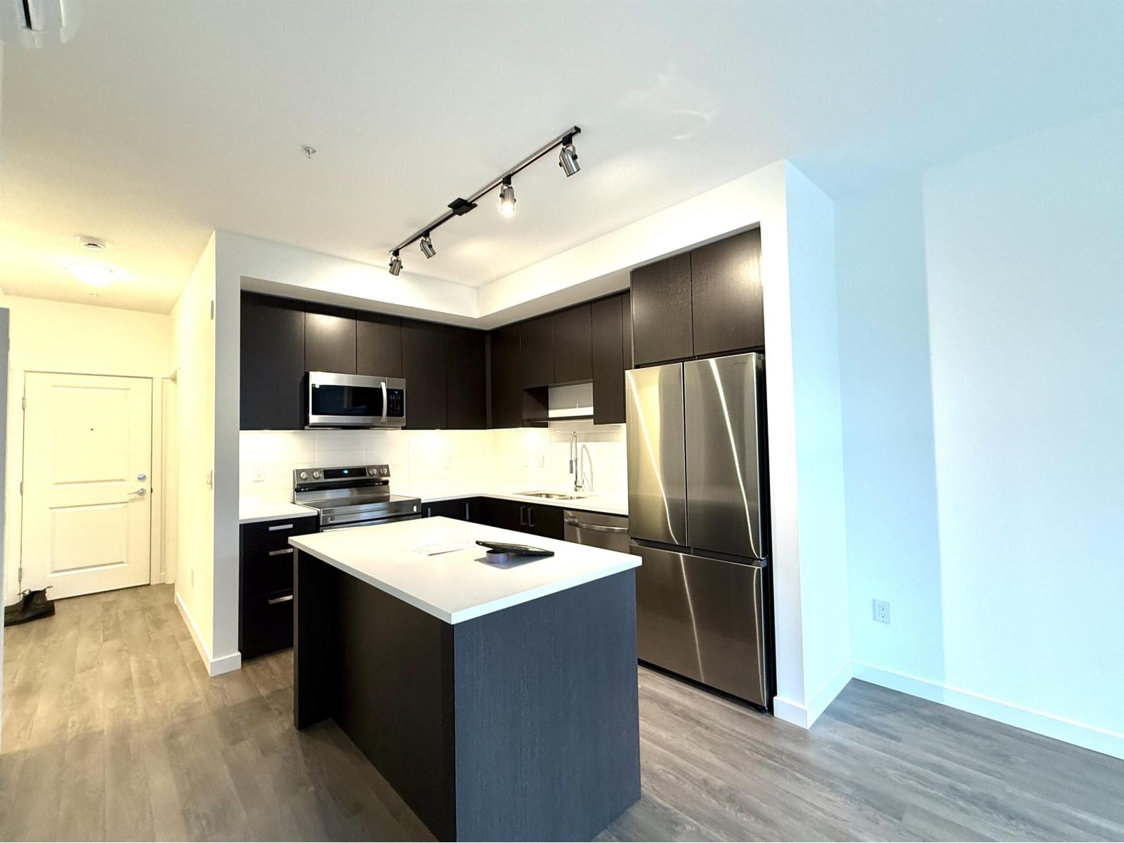 A modern kitchen with a large island in the middle.