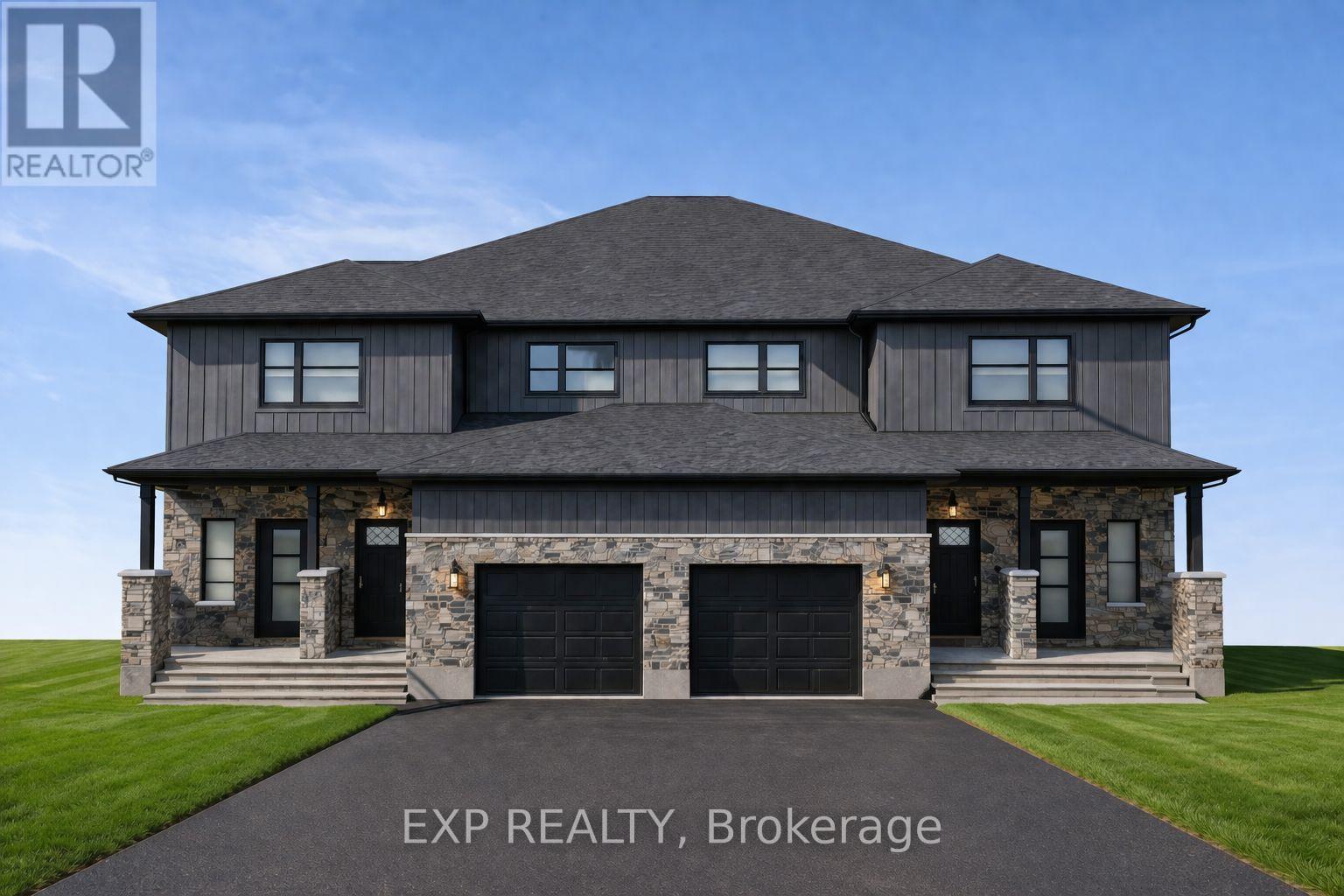 A large house with a snowy roof and garage doors.