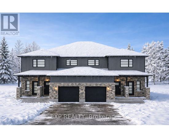 A large house with a snowy roof and garage doors.