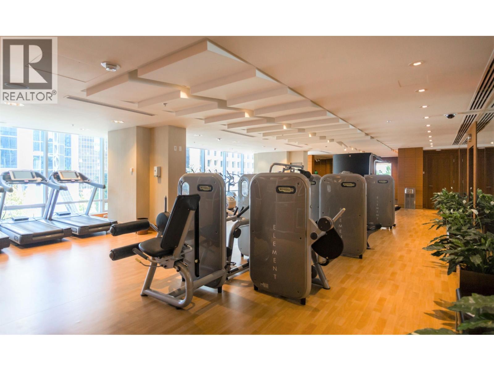 A gym with treadmills, weights, and exercise machines.