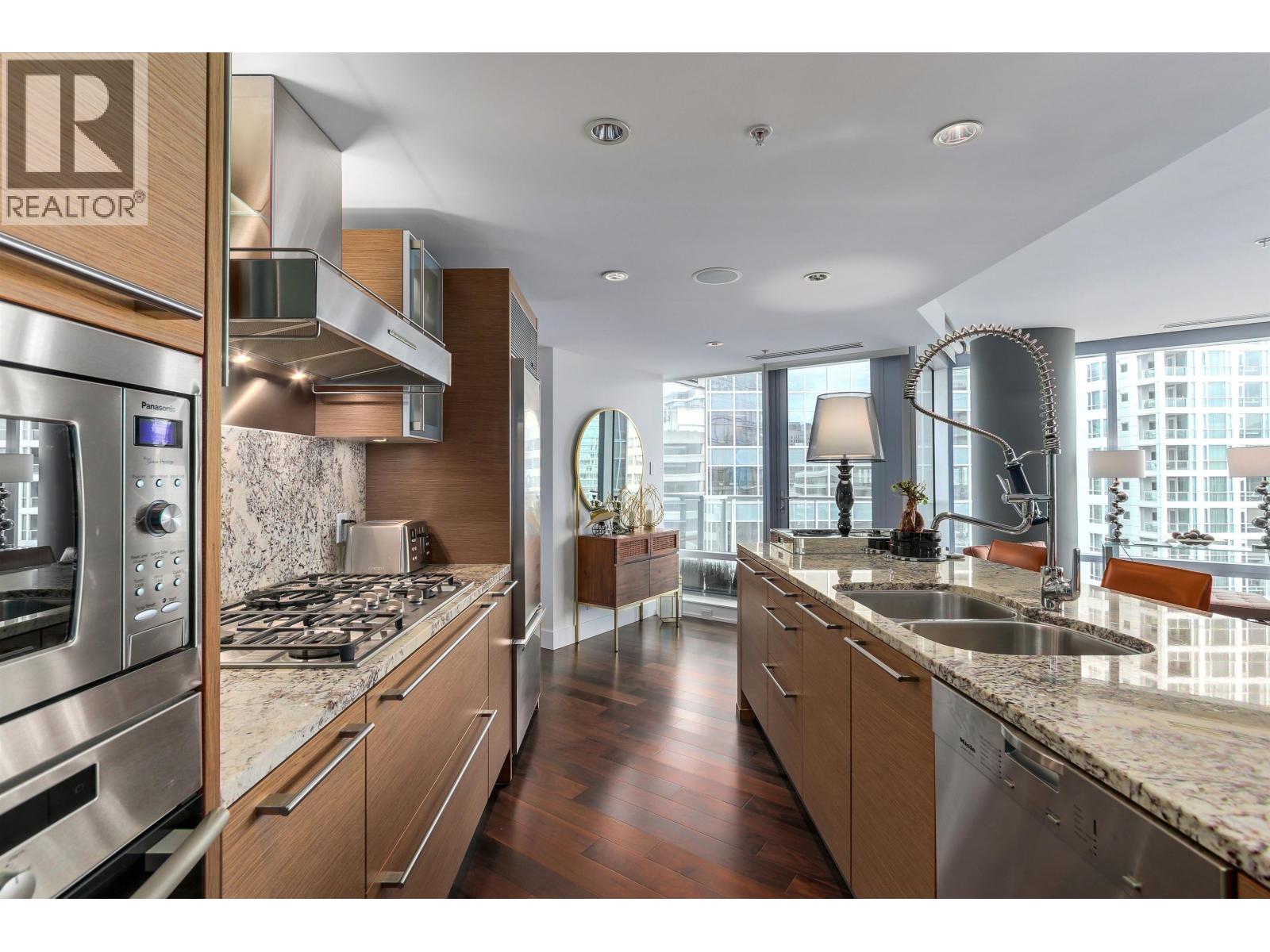 A modern kitchen with wooden cabinets and stainless steel appliances.