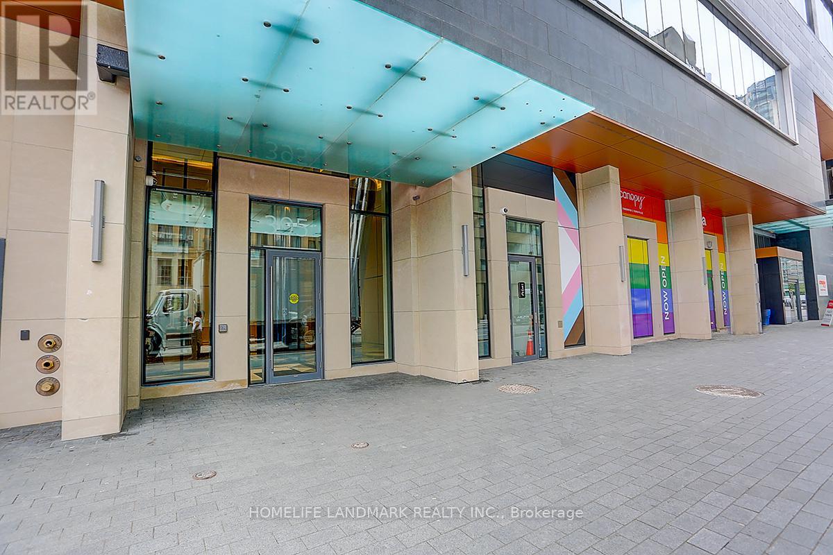 The image shows the front of a realtor's office with glass doors and a colorful awning.