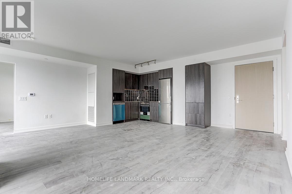 A spacious room with a grey floor and white walls.