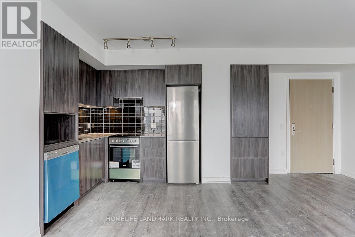 A modern kitchen with a stainless steel refrigerator and a blue dishwasher.