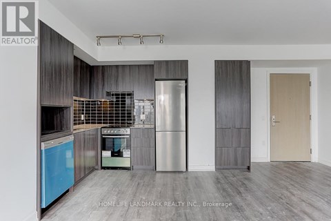 A modern kitchen with a stainless steel refrigerator and a blue dishwasher.