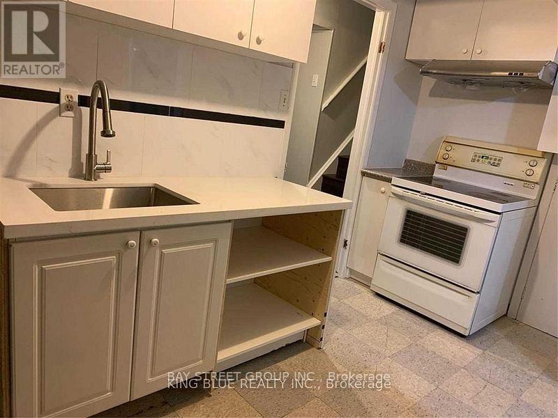 A kitchen with a sink and an oven.
