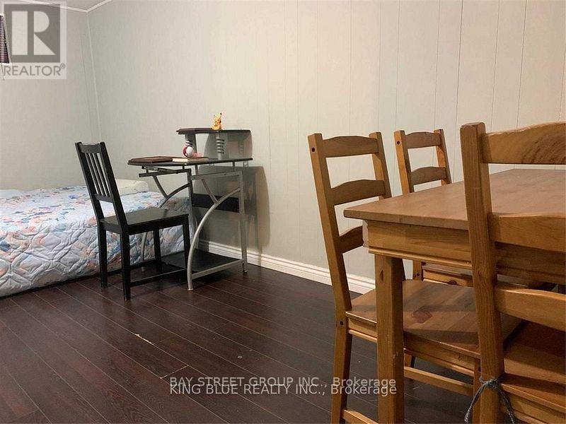A dining room with a wooden table and chairs.