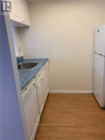 A kitchen with white cabinets and a blue countertop.