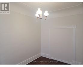 A white wall with a chandelier hanging from the ceiling.