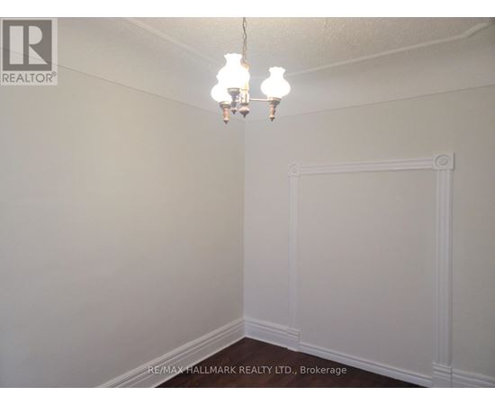A white wall with a chandelier hanging from the ceiling.