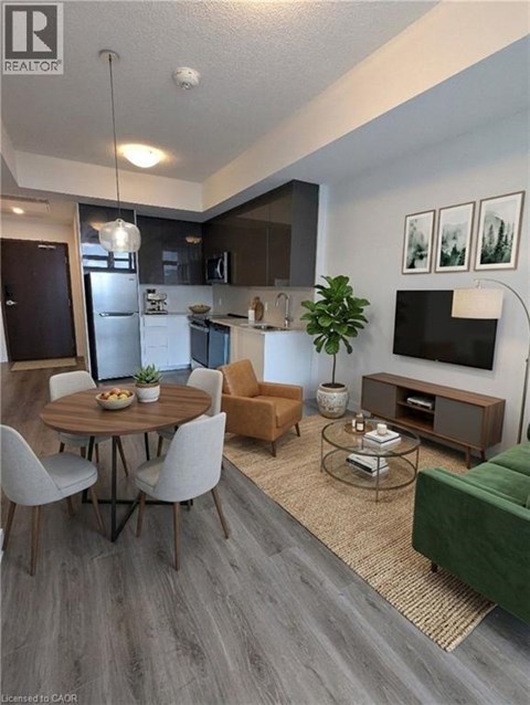 A modern living room with a dining table and chairs.