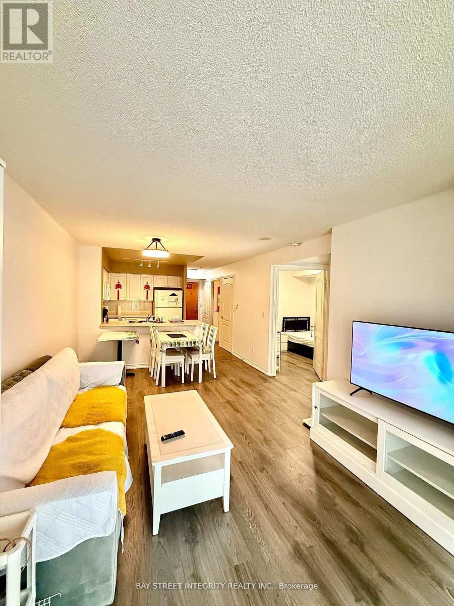 A living room with a white couch and a television.