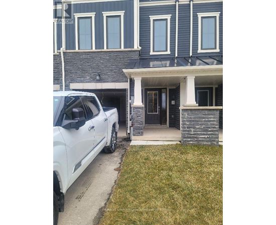 A white truck is parked in front of a house.