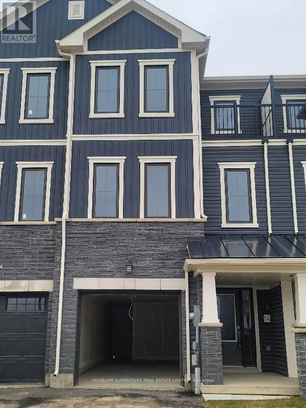 A blue house with a black garage door.