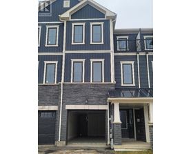 A blue house with a black garage door.