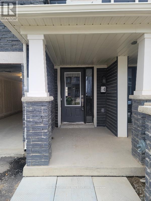 A house entrance with a dark blue door and a stone pillar.