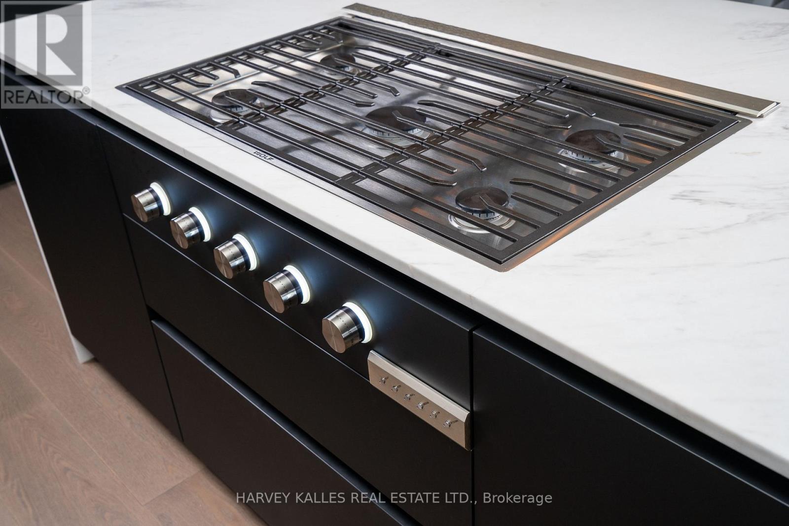 A modern kitchen with a black stove top oven.
