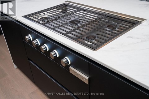 A modern kitchen with a black stove top oven.