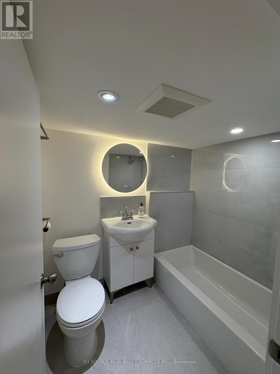 A white toilet is next to a sink in a small bathroom.