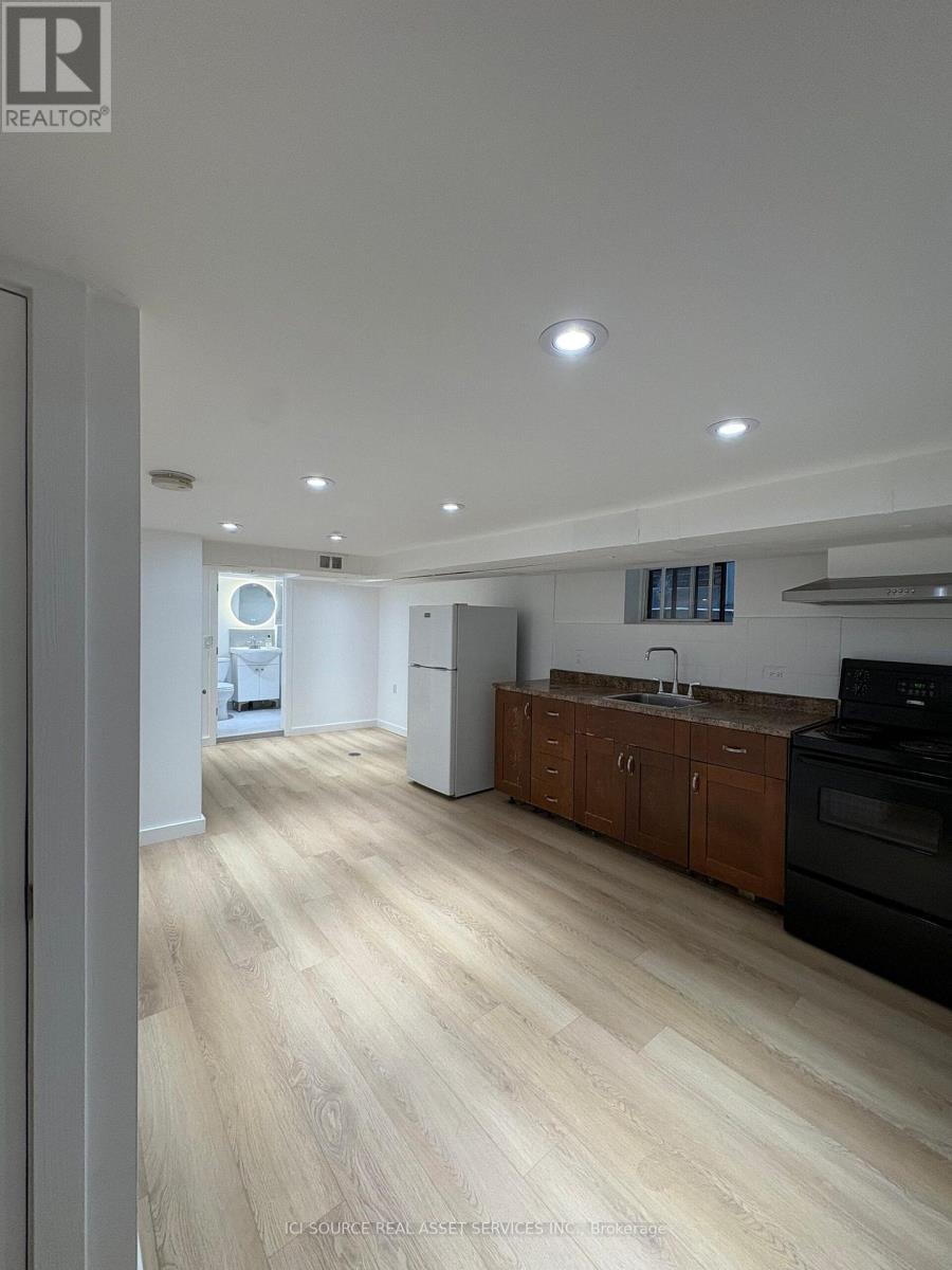 A kitchen with wooden floors and white walls.