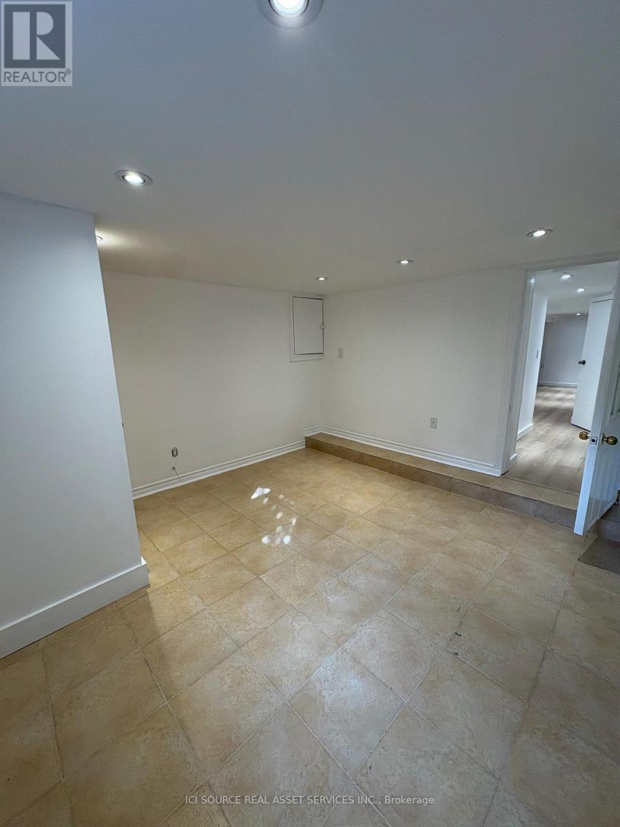 A room with beige tiled flooring and white walls.