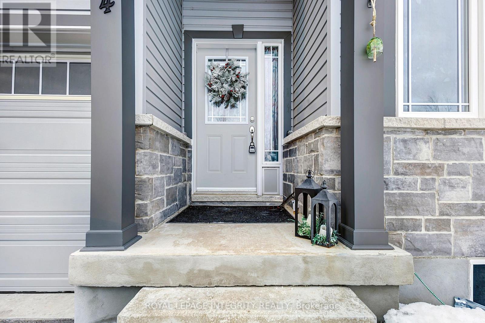 A house entrance with a wreath on the door.