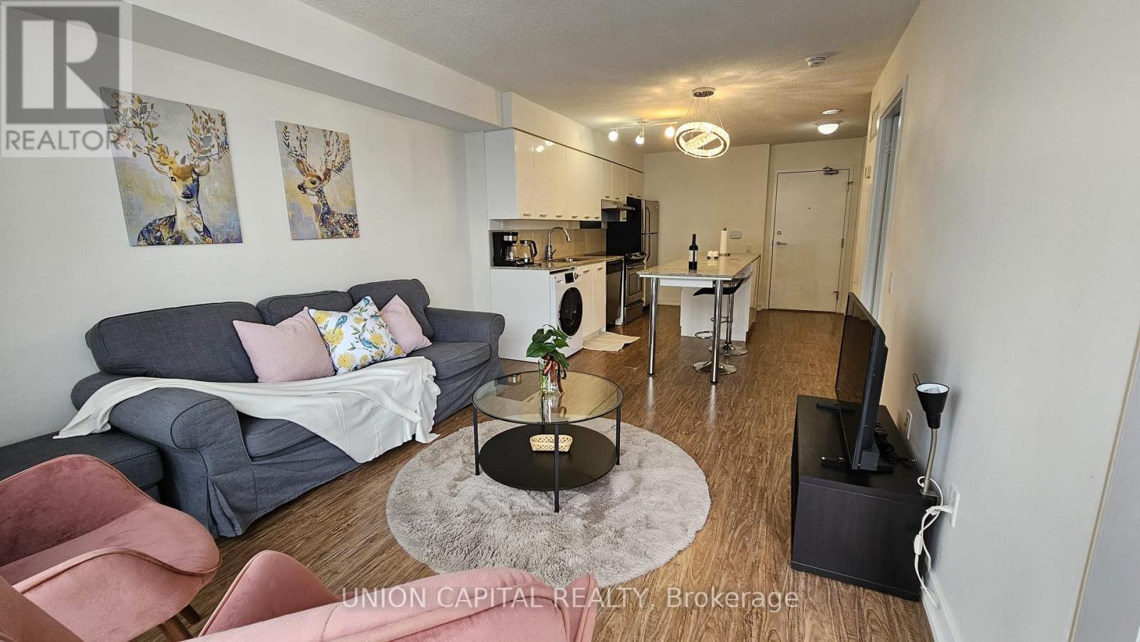A living room with a grey couch and a coffee table.