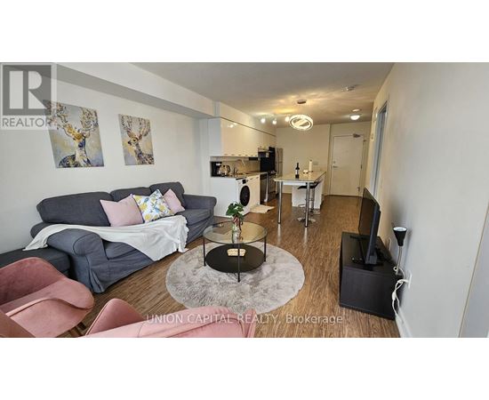 A living room with a grey couch and a coffee table.