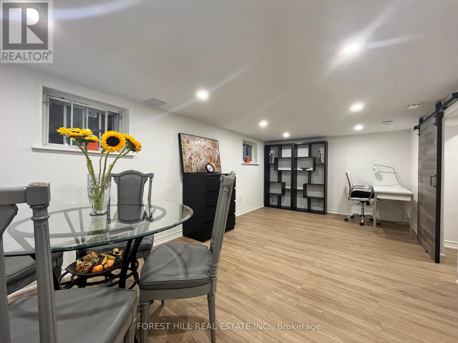 A dining area with a glass table and chairs.
