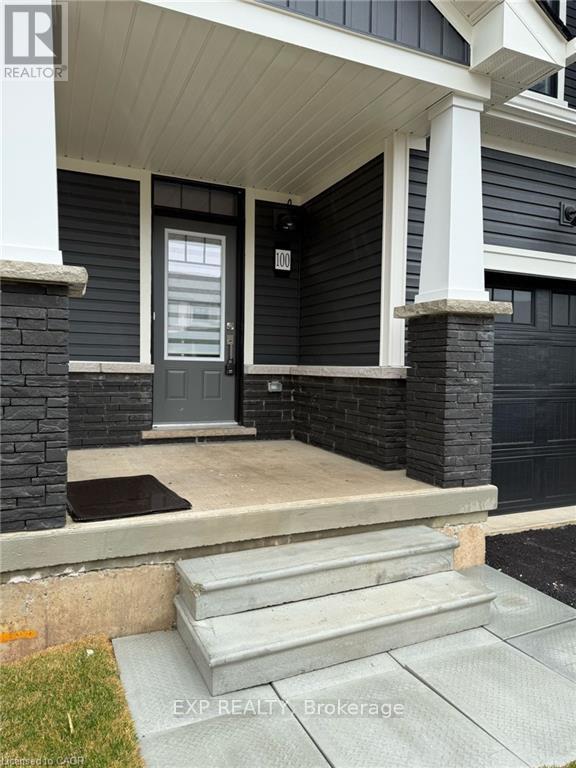 A house with a grey front door and steps leading to it.