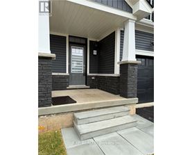 A house with a grey front door and steps leading to it.