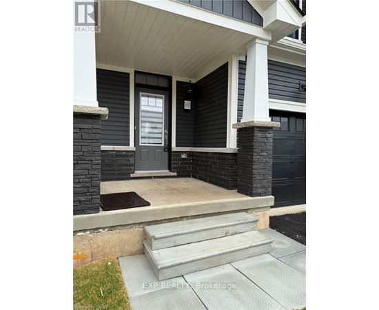 A house with a grey front door and steps leading to it.