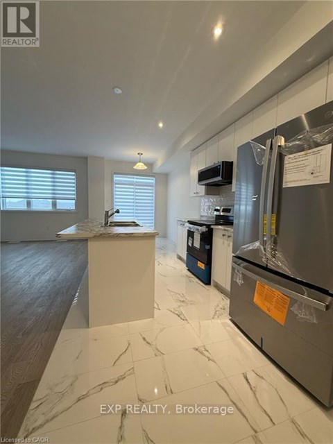 A kitchen with a refrigerator covered in plastic wrap.