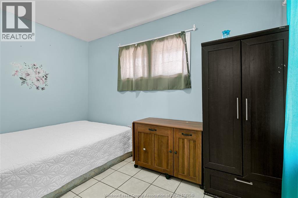 A bedroom with a bed, wardrobe and cupboard.