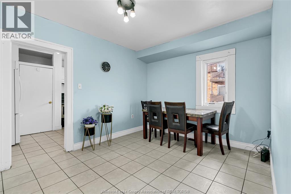 A dining room with a table and chairs.
