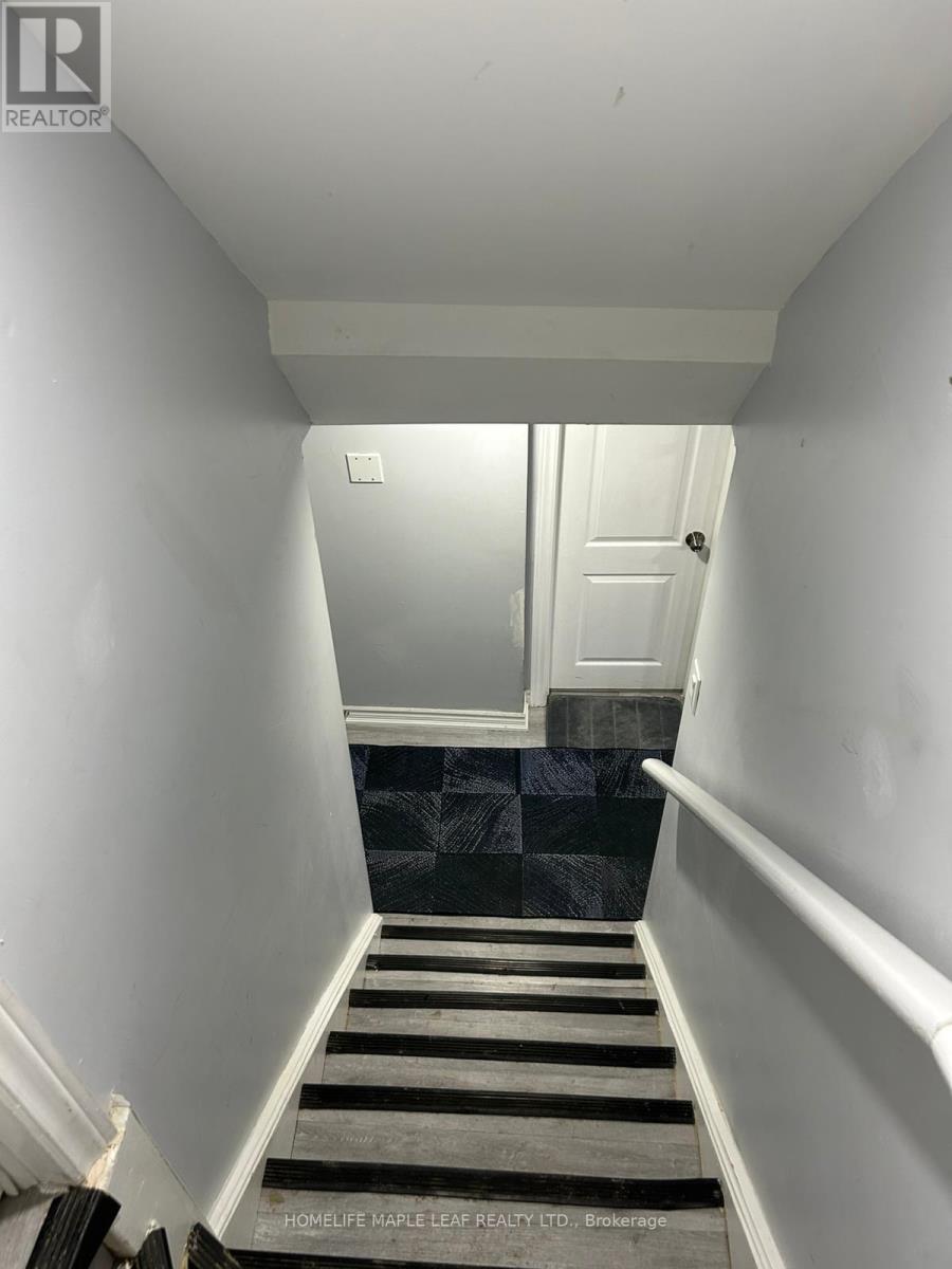 A hallway with a black and white striped carpet.