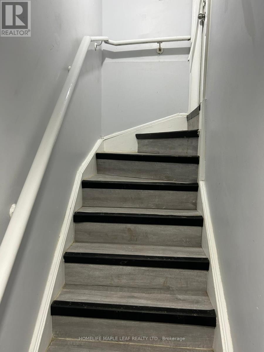 A staircase with a white railing and wooden steps.