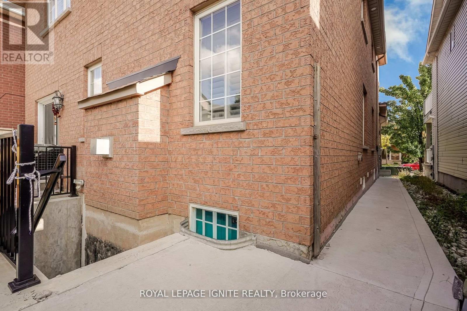 A brick building with a small window and a door.