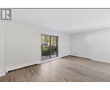 A room with a sliding glass door leading to a balcony.
